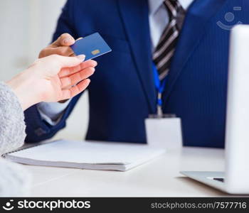 The woman makes payment with credit card. Woman makes payment with credit card