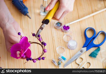 The woman making jewelry at home. Woman making jewelry at home
