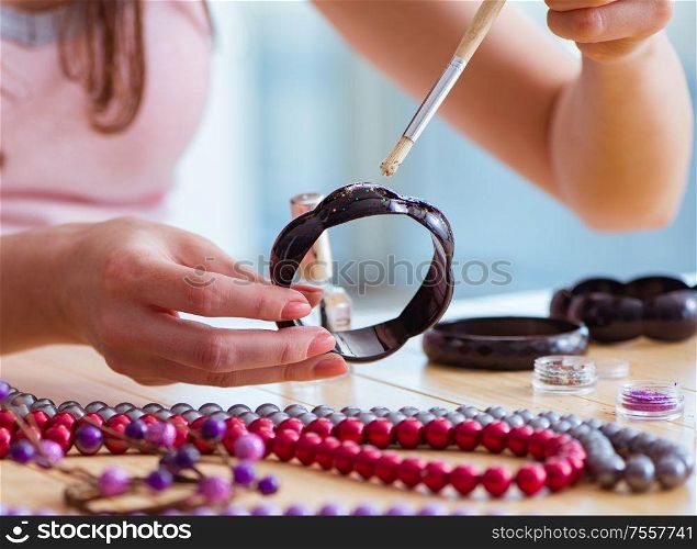 The woman making jewelry at home. Woman making jewelry at home