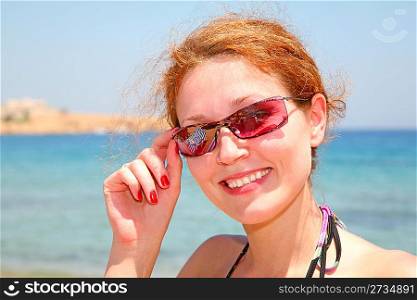 The woman on the sea in solar glasses
