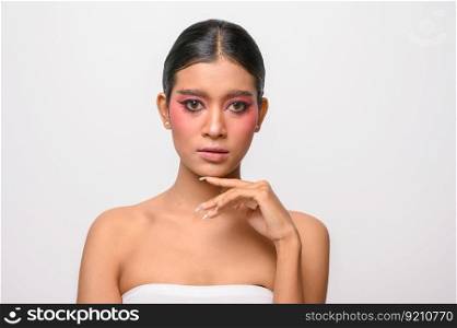 The woman put on pink makeup and put her hand on her chin. Isolated on white background