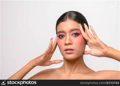 The woman put on pink makeup and put her hand on her face. Isolated on white background