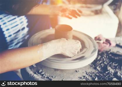 The woman&rsquo;s hands close up, the masterful studio of ceramics works with clay on a potter&rsquo;s wheel
