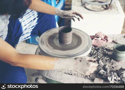 The woman’s hands close up, the masterful studio of ceramics works with clay on a potter’s wheel