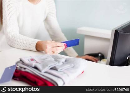 The woman-seller checks the prices for barcode. Seller conscientiously works