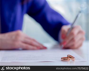 The woman signing prenuptial agreement in court. Woman signing prenuptial agreement in court