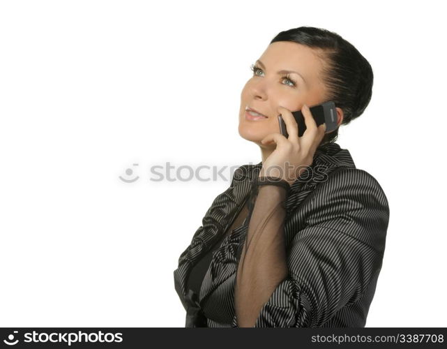 The woman talks by a mobile phone. It is isolated on a white background.