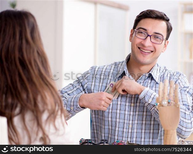 The woman visiting jeweler for jewelery evaluation. Woman visiting jeweler for jewelery evaluation