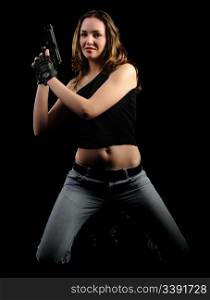 The woman with a pistol. It is isolated on a black background