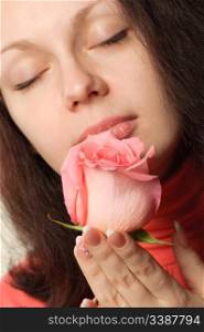 The woman with a rose. A photo close up parts of the person and a flower