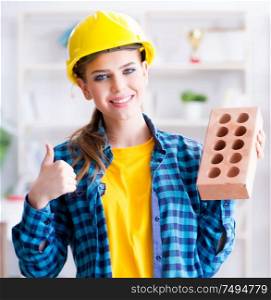 The woman with brick in construction concept. Woman with brick in construction concept