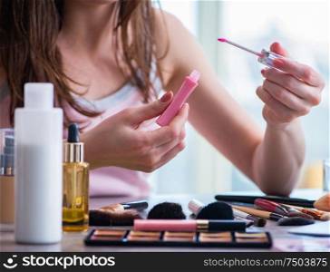 The woman with make-up accessories in beauty concept. Woman with make-up accessories in beauty concept