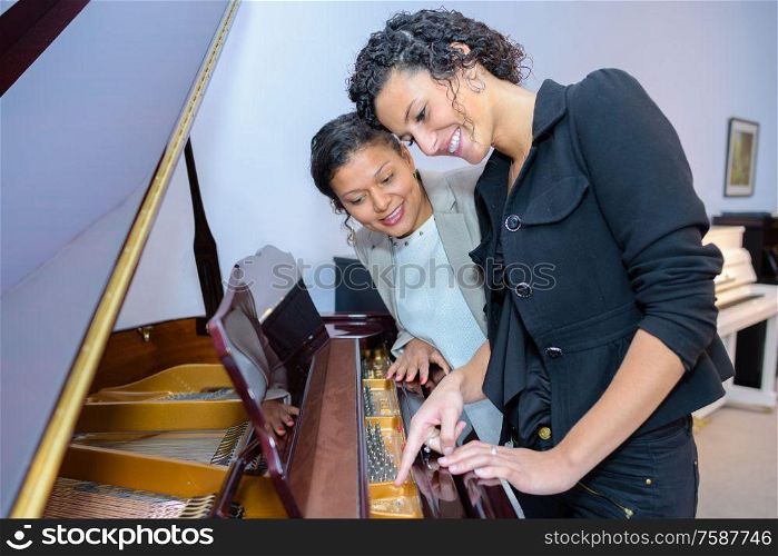 the women looking at piano