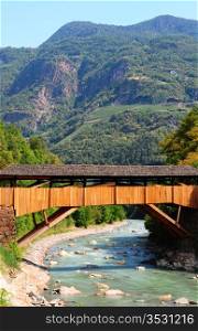 The Wooden Bridge Over the Adige River at the Foot of the Italian Alps