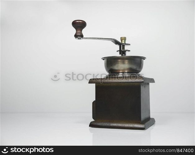 The wooden coffee grinder on grey background