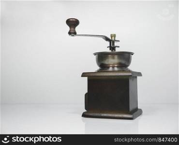 The wooden coffee grinder on grey background