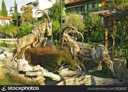 The wooden sculpture of two goats in Mermerli park, old town Kaleici Antalya Turkey