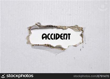 The word accident appearing behind torn paper