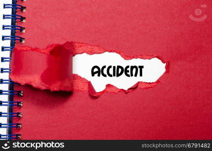 The word accident appearing behind torn paper