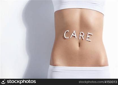 The word &acute;care&acute; in the abdomen of a young girl