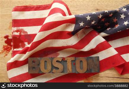 the word Boston on a bloodied American flag
