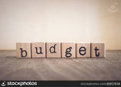 The word Budget, vintage blank space background.. The word Budget, text on wooden cubes on table top. Background copy space, vintage minimal style. Concepts for business management, financial plan, investment fund and money saving.