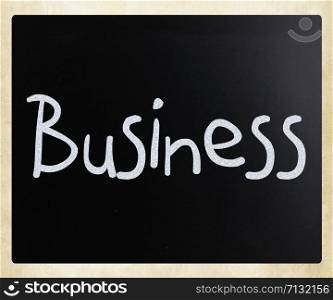 "The word "Business" handwritten with white chalk on a blackboard"