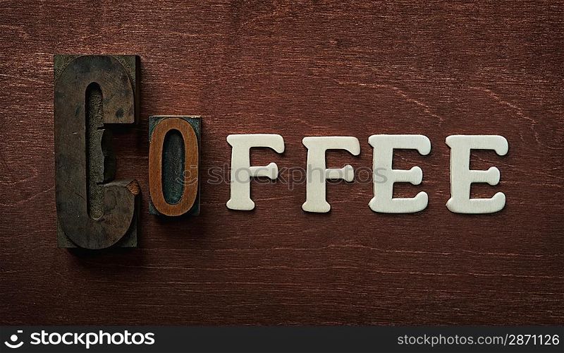 The word coffee written on wooden background