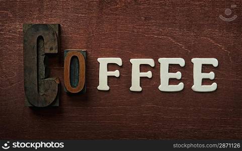 The word coffee written on wooden background
