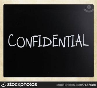 "The word "Confidential" handwritten with white chalk on a blackboard"
