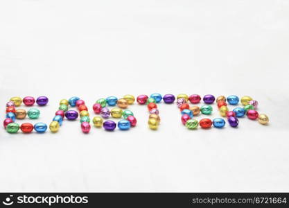 "The word "easter" spelled in chocolate easter eggs"