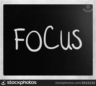 "The word "Focus" handwritten with white chalk on a blackboard"