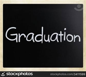 "The word "Graduation" handwritten with white chalk on a blackboard"