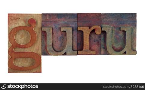 the word guru in vintage wooden letterpress type blocks, stained by color ink, isolated on white