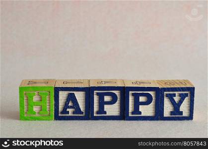 The word happy spelled with colorful blocks isolated on a white background