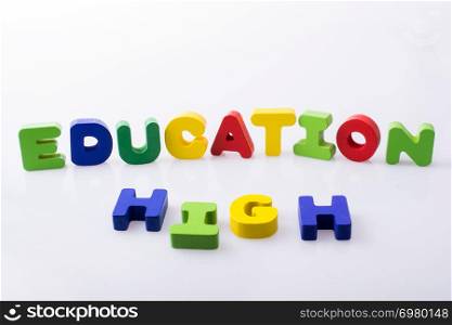 the word HIGH EDUCATION written with colorful letter blocks