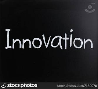 "The word "Innovation" handwritten with white chalk on a blackboard"