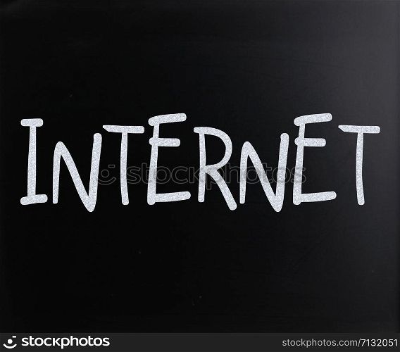 "The word "Internet" handwritten with white chalk on a blackboard"
