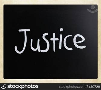 "The word "Justice" handwritten with white chalk on a blackboard"
