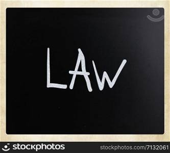 "The word "Law" handwritten with white chalk on a blackboard"