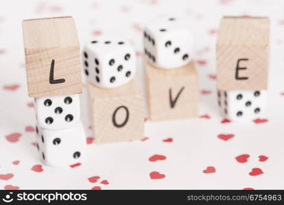 The word love alongside white dice.