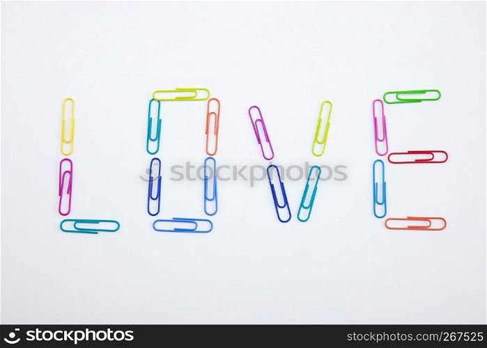 The word LOVE made from colorful paperclips, Top view closeup.