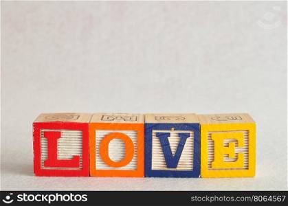 The word love spelled with colorful blocks isolated on a white background