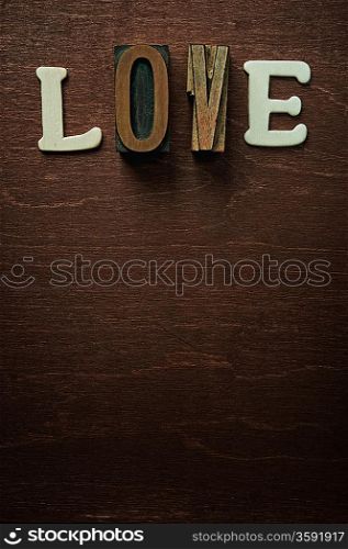 The word love written on wooden background