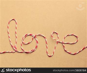 "The word "love" written with rope, retro filter effect"