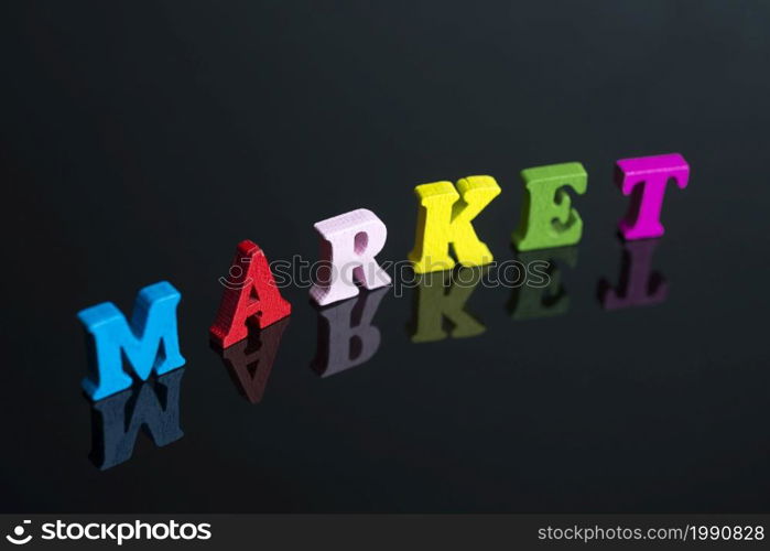 The word market of colored letters on black background.. The word market on the black background.