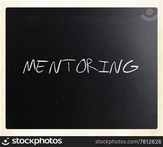 "The word "Mentoring" handwritten with white chalk on a blackboard."