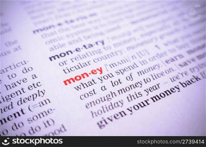 the word money in a glossary, macro, violet toning
