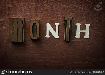 The word month written on wooden background
