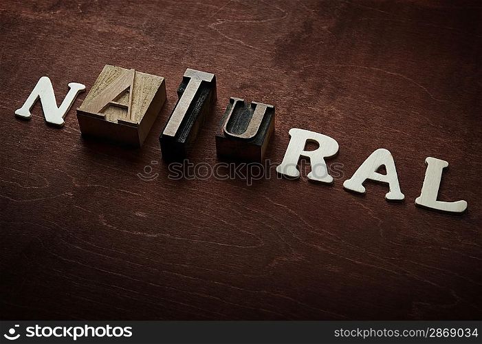 The word natural written on wooden background